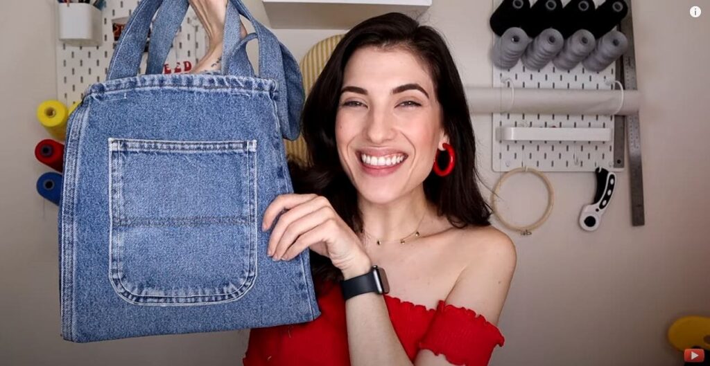 An image from a YouTube video showing a woman crafting a tote bag using denim jeans.