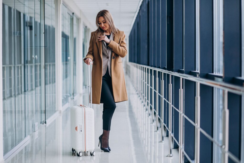 Business woman with travel bag in airport