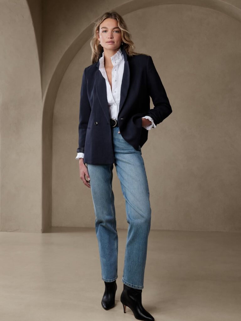 Woman dressed in a blazer, t-shirt, and jeans