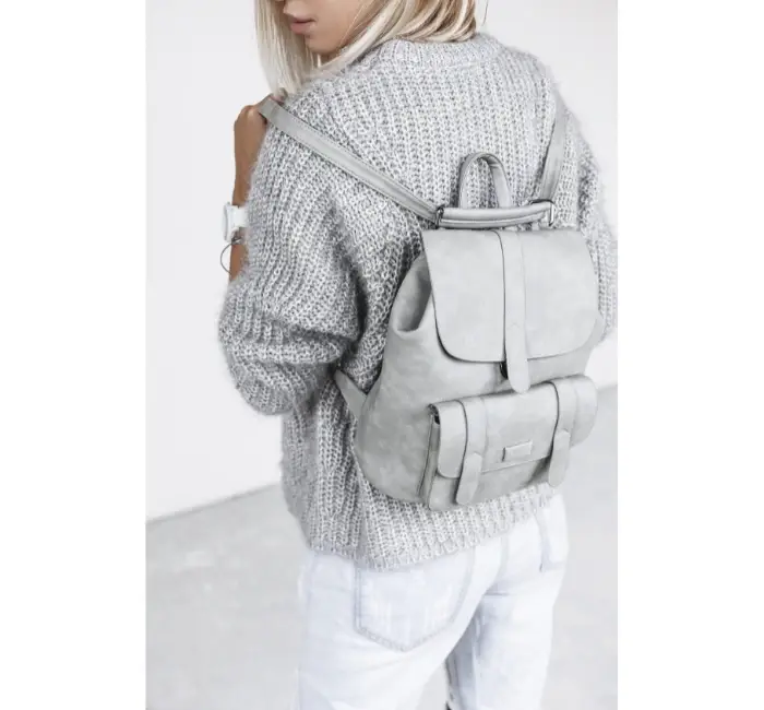 Girl wearing minimalist grey backpack