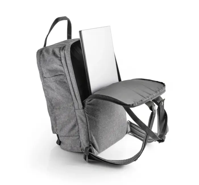 Minimalist backpack with an open zip with laptop in it