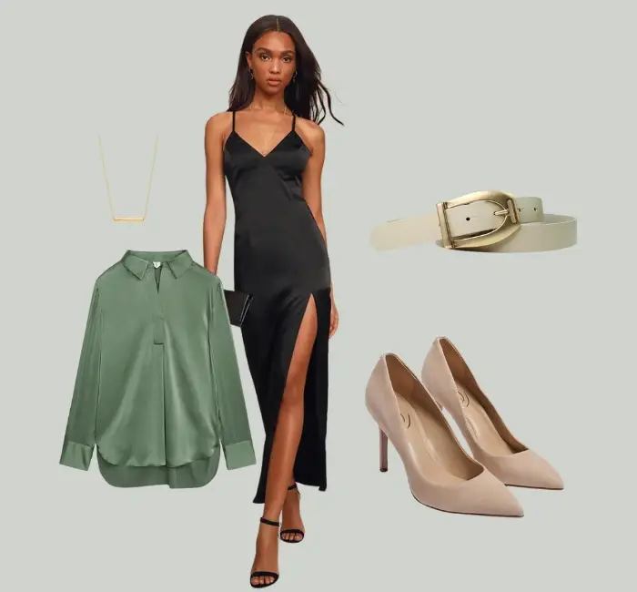 Chic layered outfit featuring a sage green blouse styled over a black satin slip dress, paired with beige heels and a statement belt for a polished look.