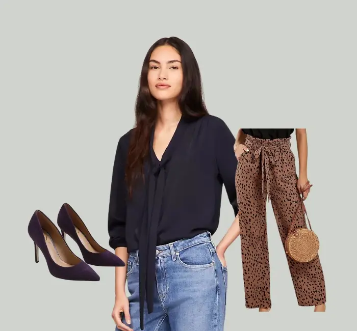 Elegant outfit featuring a navy tie-neck blouse, animal print paper bag trousers, and suede heels for a polished yet trendy look.