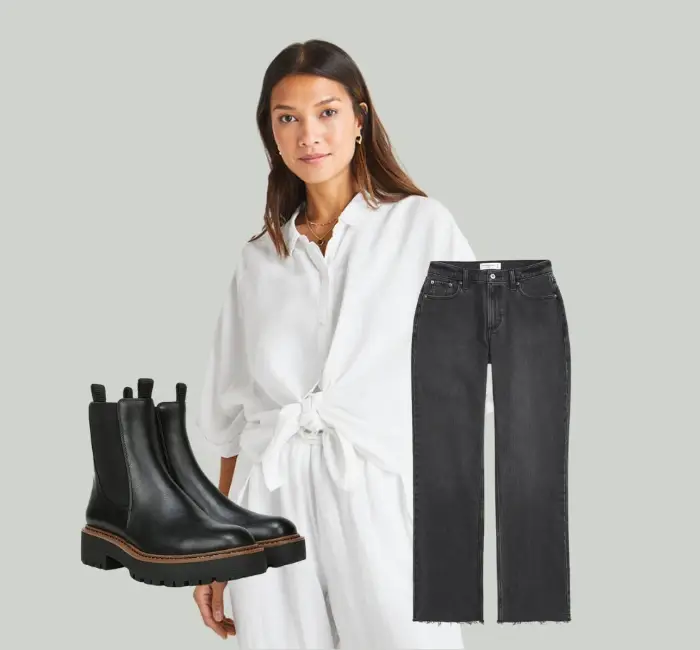 A woman wearing a white tie-front blouse paired with high-waisted wide-leg jeans and ankle boots, exemplifying versatile tie front blouse outfit ideas for various occasions.