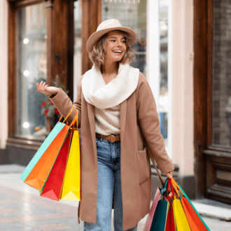 Smiling woman with shopping bags, enjoying ethical shopping experience