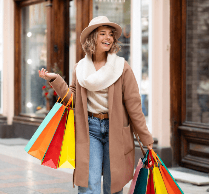 Smiling woman with shopping bags, enjoying ethical shopping experience