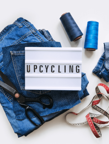 upcycle your old clothes with Denim Upcycling Ideas using Old Jeans: Repurposing and Reusing with Upcycle Clothes, Upcycle Fashion, and Upcycle Old Clothes. Lightbox with Text Upcycling, Stack of Old Blue Jeans, Scissors, Thread, and Sewing Tools in Sewing Studio.