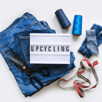 upcycle your old clothes with Denim Upcycling Ideas using Old Jeans: Repurposing and Reusing with Upcycle Clothes, Upcycle Fashion, and Upcycle Old Clothes. Lightbox with Text Upcycling, Stack of Old Blue Jeans, Scissors, Thread, and Sewing Tools in Sewing Studio.