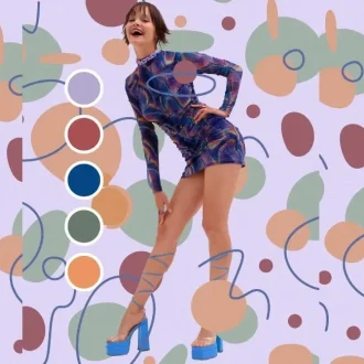 A woman dressed in a vibrant, multicolored outfit stands against a background of abstract patterns. The image showcases the practical application of color theory in fashion. The woman’s outfit features shades of blue, green, and orange, demonstrating how different colors can be harmonized to create a stylish look.