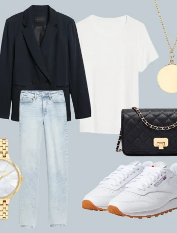 Fall capsule wardrobe 2023: An ensemble from the autumn capsule collection featuring a white shoe, a navy blue blazer, light wash denim jeans, a golden necklace and watch, completed with a black cross-body bag and crisp white shirt.