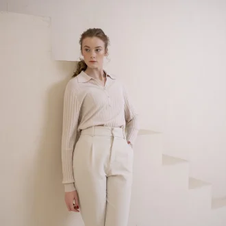 Elegant woman in sustainable minimalist fashion shirt embodying chic and conscious style.