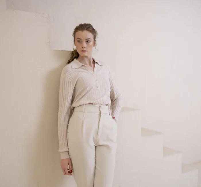 Elegant woman in sustainable minimalist fashion shirt embodying chic and conscious style.