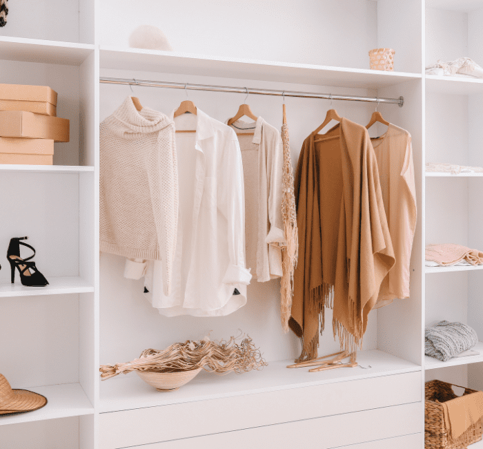 Capsule wardrobe displaying a curated selection of stylish female clothing items, organized for easy access and mixing.