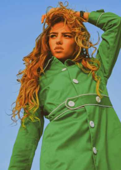 This image showcases the seasonal fashion for autumn, featuring a woman dressed in a green coat that embodies vogue style. The outfit color of the coat adds to the overall aesthetic of the image.