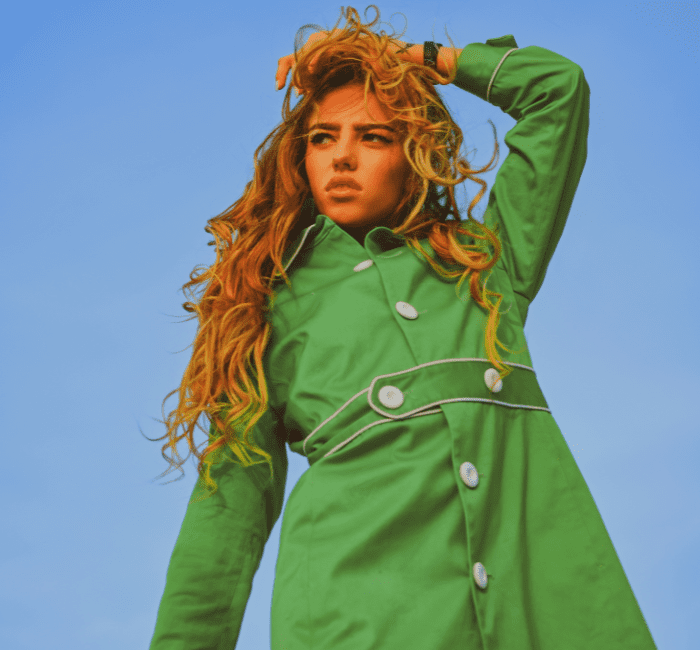 This image showcases the seasonal fashion for autumn, featuring a woman dressed in a green coat that embodies vogue style. The outfit color of the coat adds to the overall aesthetic of the image.