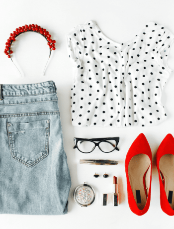 A captivating collage of chic feminine attire and accessories, artfully arranged in a flat lay composition on a pristine white backdrop. This stylish ensemble, featuring a blouse, jeans, sleek eyewear, lush mascara, bold lipstick, fiery red high heels, and dazzling earrings and hoops, creates a harmonious fusion of match outfits, perfect for any fashion-forward woman.